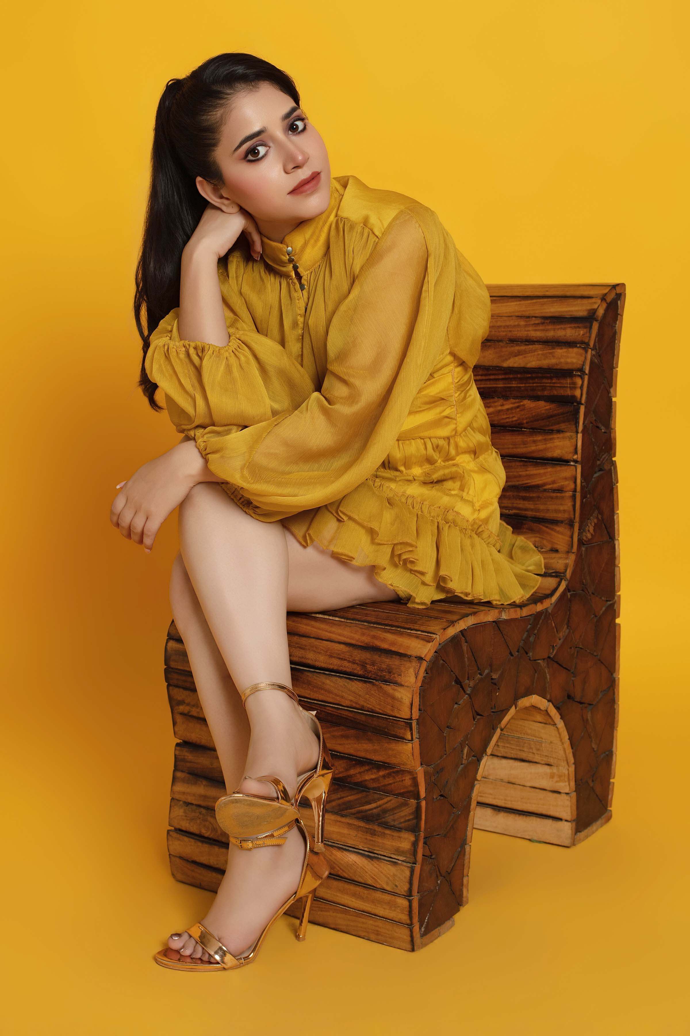 Neeru Sharma smiling candidly in a mustard dress